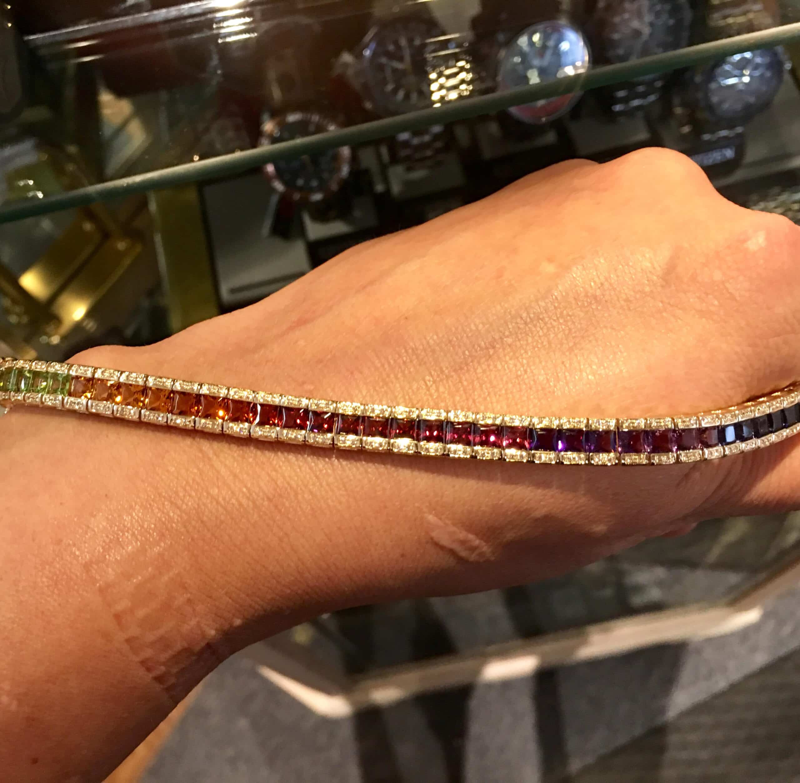 This 14kyg bracelet with multi-color square cut stones and round diamond accents is vibrant, elegant, and sure to please.