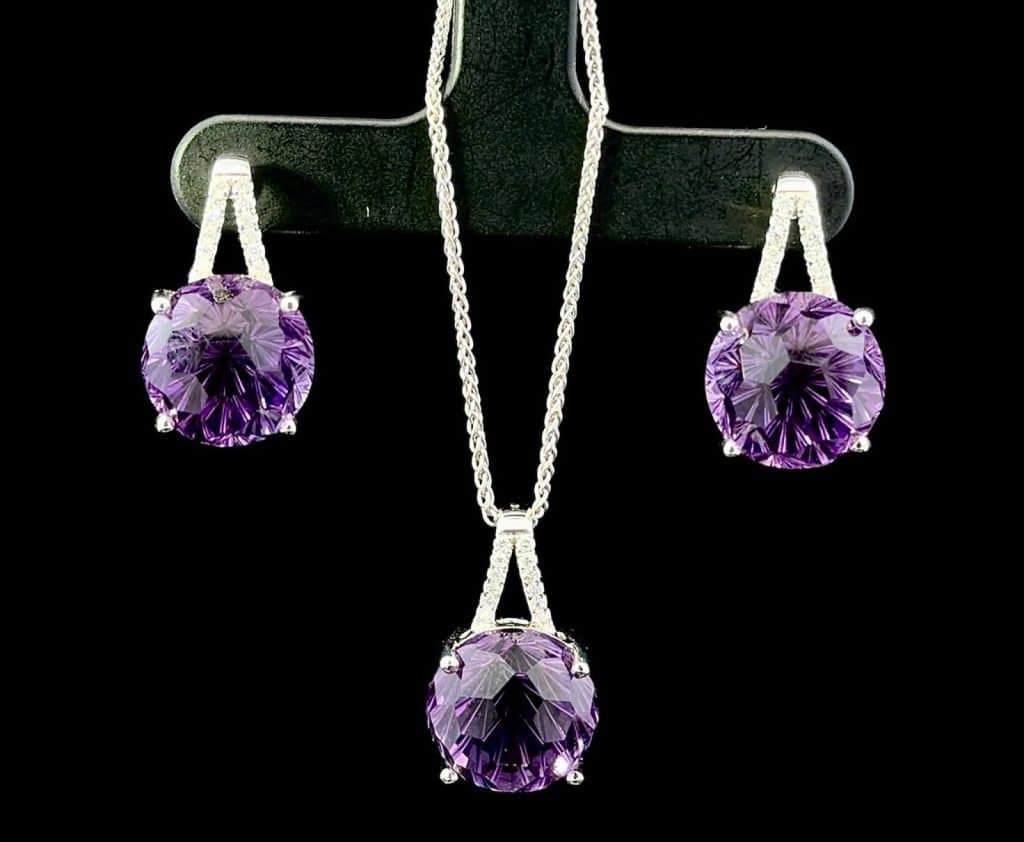 Amethyst earrings and pendant on a black background