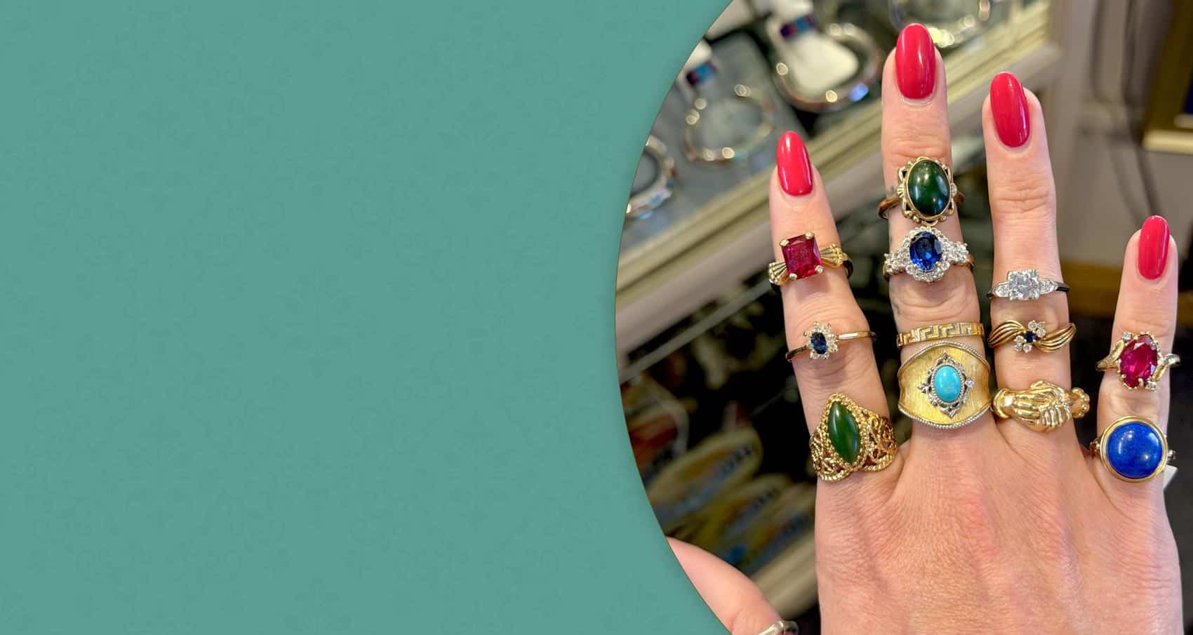 close up of womans hand with multiple gemstone rings on each finger