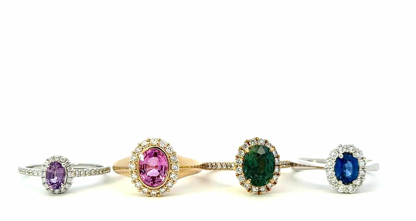 row of four sapphire rings sitting on a white background